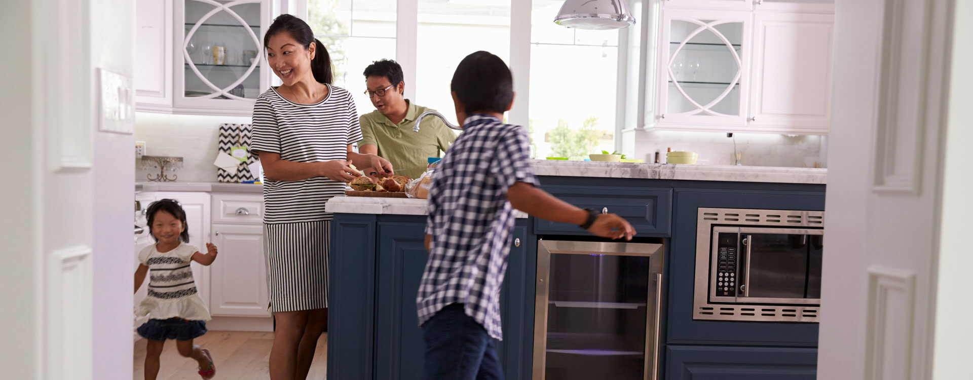 Family gathered in kitchen in comfortable home